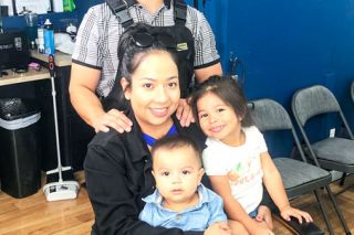 Kirby Neumann-Rea##Proper Cuts owners Alberto and Margarita Garcia, with their children, Margali, 4, and Roman, 1.