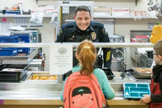Rusty Rae/News-Register

Carlton police Chief Kevin Martinez is all smiles as he takes a breakfast order from a  student at the Yamhill-Carlton Elementary School Tuesday morning. Police visit the school frequently so students know then as friendly faces.