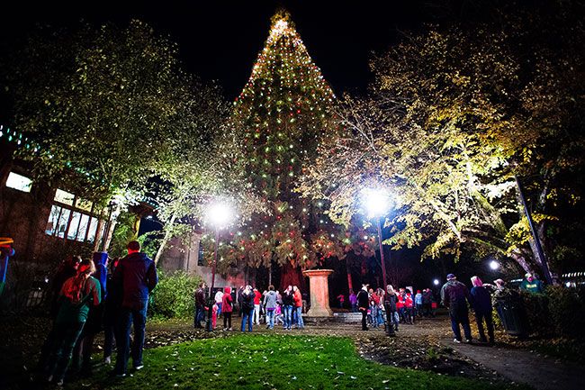 Marcus Larson / News-Register##
Adults and children sing carols as McMinnville s Giant Sequoia is lighted for the first time in 12 years.