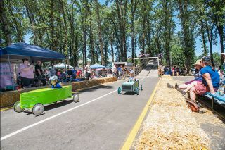 Rusty Rae/News-Register##Maverick Williams, in green soap box car at left, races Raylan Gephart in a preliminary race in the home built division Saturday at Beulah Park in Yamhill. Luke Skipper won the division and Gephart finished second. For more on the races, see A12.