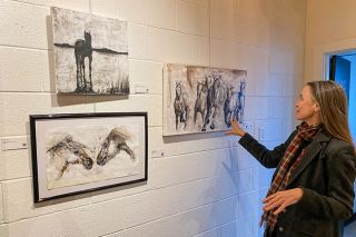 Starla Pointer/News-Register##McMinnville artist Isabelle Truchon shows off some of her smaller studies and ink drawings, including one of horses running and another of a horse silhouetted at the edge of a river.