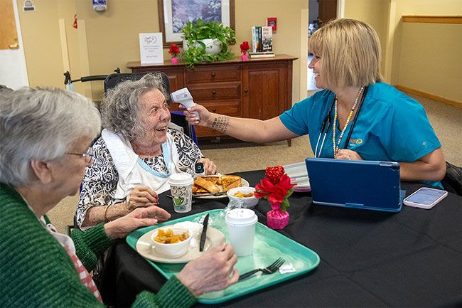 Rusty Rae/News-Register##Betty Graves, center, enjoys talking with hospice nurse Ashley Miller as she checks her vital signs at the end of the lunch hour. Graves is sitting with Tad Pappas, left, a longtime friend. The women said they keep track of one another and often share meals together.
