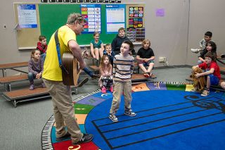 Rusty Rae/News-Register##Faulconer-Chapman third-grader Kaleb Myatt joins music teacher Jon Sherwood as he plays guitar during a lesson Tuesday. Students at the Sheridan school have numerous new instruments for learning musical concepts, thanks to a donation from the Snowman Foundation’s Play It Forward program.