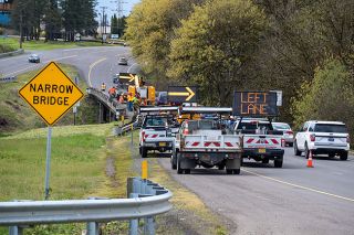 Rachel Thompson/News-Register##Southbound traffic rolls past an ODOT work crew Sunday morning on Highway 99W near Cascade Steel Rolling Mills after a vehicle struck and damaged the guardrail of a bridge over the Yamhill River.
