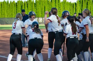 Rachel Thompson/News-Register##Gabby Chupp is met at home plate by her teammates after smashing a sixth-inning home run to take a 5-4 lead in Dayton’s win over Yamhill-Carlton on Wednesday. The previous batter, Charly Upmeyer, tied the game with a homer of her own. Rachel Thompson/News-Register##Gabby Chupp is met at home plate by her teammates after smashing a sixth-inning home run to take a 5-4 lead in Dayton’s win over Yamhill-Carlton on Wednesday. The previous batter, Charly Upmeyer, tied the game with a homer of her own.