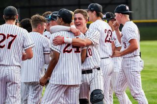 Rusty Rae/News-Register##Drew Bizon embraces Bryce Wilson following the Grizzlies walk-off quarterfinal victory over South Medford Friday at home. Rusty Rae/News-Register##Drew Bizon embraces Bryce Wilson following the Grizzlies walk-off quarterfinal victory over South Medford Friday at home.