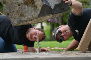 Rachel Thompson/News-Register##Karl Wolff of WORX Construction and Brian Wicks of Cascadia Landscaping carefully maneuver the tall section of a new public art sculpture at Second and Cowls streets onto a pin that will help it stay upright. Placing the 4,000-pound piece required several lifts, turns and fine adjustments. Rachel Thompson/News-Register##Karl Wolff of WORX Construction and Brian Wicks of Cascadia Landscaping carefully maneuver the tall section of a new public art sculpture at Second and Cowls streets onto a pin that will help it stay upright. Placing the 4,000-pound piece required several lifts, turns and fine adjustments.