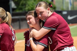 Nathan Ecker/News-Register##Senior Rylie Hedgecock leans on sophomore shortstop Isabella Lopez after the Pirates 9-3 loss to Scio in the 3A softball State Championship game at Jane Sanders Stadium in Eugene. The game marked Dayton’s first championship appearance since 2019, but they could not come back against Scio who won their first softball title in school history. Nathan Ecker/News-Register##Senior Rylie Hedgecock leans on sophomore shortstop Isabella Lopez after the Pirates 9-3 loss to Scio in the 3A softball State Championship game at Jane Sanders Stadium in Eugene. The game marked Dayton’s first championship appearance since 2019, but they could not come back against Scio who won their first softball title in school history.