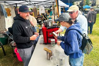 Kirby Neumann-Rea/News-Register##Josh Gordon of Evasion Brewing, left, shares a laugh as he talks about the Yamhill County Beer Passport with Mark and Jennifer Angelus of McMinnville, at the Oregon Brews & BBQ. Kirby Neumann-Rea/News-Register##Josh Gordon of Evasion Brewing, left, shares a laugh as he talks about the Yamhill County Beer Passport with Mark and Jennifer Angelus of McMinnville, at the Oregon Brews & BBQ.