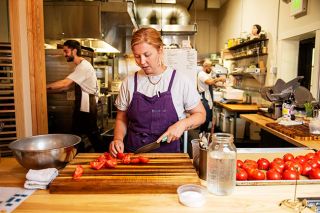 Rusty Rae/News-Register##James Beard Award nominated Chef Kari Shaughnessy cuts ripe tomatoes in the kitchen of Hayward, which she founded in 2023. Behind her are kitchen team members Zack Ralston, left, and Jon Inonueri, right. Hayward moved from its original location in Mac Market to 209 N. Kutch St. in Carlton this month. Rusty Rae/News-Register##James Beard Award nominated Chef Kari Shaughnessy cuts ripe tomatoes in the kitchen of Hayward, which she founded in 2023. Behind her are kitchen team members Zack Ralston, left, and Jon Inonueri, right. Hayward moved from its original location in Mac Market to 209 N. Kutch St. in Carlton this month.