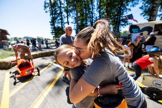 Rachel Thompson/News-Register##Charleigh, 9, gets a victory hug from her mom, Stacey, after winning first place overall in the Derby Days race. Charleigh’s car — built 42 years ago by her grandfather, John VanDyke — took home the top prize after beating a kit car, a rare feat for a home-built racer. Rachel Thompson/News-Register##Charleigh, 9, gets a victory hug from her mom, Stacey, after winning first place overall in the Derby Days race. Charleigh’s car — built 42 years ago by her grandfather, John VanDyke — took home the top prize after beating a kit car, a rare feat for a home-built racer.