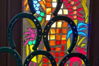 Kirby Neumann-Rea/News-Register##The horseshoe theme at The One Horse Tavern in Gaston continues in the colorful windows around the front door. Kirby Neumann-Rea/News-Register##The horseshoe theme at The One Horse Tavern in Gaston continues in the colorful windows around the front door.