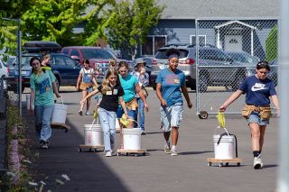 Rachel Thompson/News-Register##Girls Build participants wheel their tools to the next build station during the camp last week in Sheridan. On the first day, the girls designed wheel buckets, which act as rolling luggage to keep all their equipment and protective gear together. Rachel Thompson/News-Register##Girls Build participants wheel their tools to the next build station during the camp last week in Sheridan. On the first day, the girls designed wheel buckets, which act as rolling luggage to keep all their equipment and protective gear together.