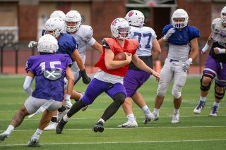 Linfield redshirt senior quarterback Luke McNabb scrambles down the turf at Maxwell Field during an intrasquad scrimmage on Saturday, Aug. 30. McNabb is tabbed to be the Wildcats starting QB against UW-Oshkosh on Sept. 6.##Rusty Rae/News-Register Linfield redshirt senior quarterback Luke McNabb scrambles down the turf at Maxwell Field during an intrasquad scrimmage on Saturday, Aug. 30. McNabb is tabbed to be the Wildcats starting QB against UW-Oshkosh on Sept. 6.##Rusty Rae/News-Register