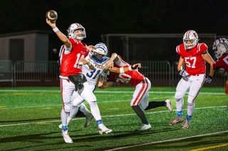 Rusty Rae/News-Register##Senior quarterback Drew Bizon lets the ball loose as pressure closes in during the Grizzlies loss to Newberg at Wortman Stadium on Thursday, Oct. 9. Bizon completed six of 12 passes for 57 yards. Rusty Rae/News-Register##Senior quarterback Drew Bizon lets the ball loose as pressure closes in during the Grizzlies loss to Newberg at Wortman Stadium on Thursday, Oct. 9. Bizon completed six of 12 passes for 57 yards.