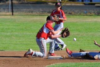 Rusty Rae/News-Register##
Brandon Aird takes a throw from JBO catcher Morgan Ronning during action in the game against Banks. Rusty Rae/News-Register##
Brandon Aird takes a throw from JBO catcher Morgan Ronning during action in the game against Banks.