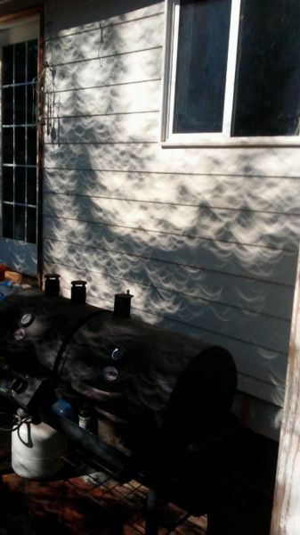 Submitted by Leona Cliff Atkinson##Shadows on my daughter s house on Elmwood in McMinnville after totality.
