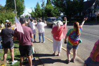 Starla Pointer / News-Register##Participants in an impromptu peace and diversity rally wave a passing traffic Friday morning. Starla Pointer / News-Register##Participants in an impromptu peace and diversity rally wave a passing traffic Friday morning.
