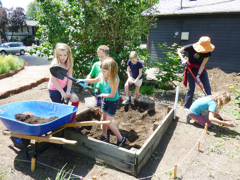 Montessori students garden for Maria