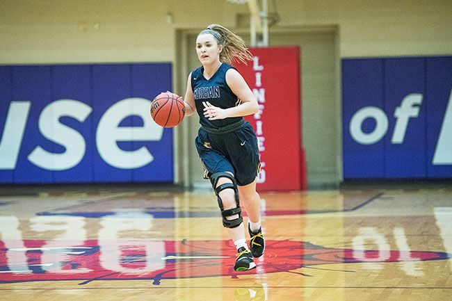 Rusty Rae/News-Register##
Corban point guard and Dayton High School alum Shawnie Spink pushes the tempo during the Warriors’ 58-40 road loss to Linfield Monday at Ted Wilson Gymnasium.