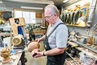 Marcus Larson/News-Register##Local woodworker Dan Heins describes the many different kinds of products he creates for customers, including finely crafted wood bowls that he turns  on his lathe.