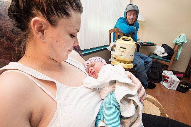 Marcus Larson/News-Register##Molly Phipps holds Skylar Meierotto while father Bryan Meierotto looks on. Skylar was the first baby of the new year born at Willamette Valley Medical Center.