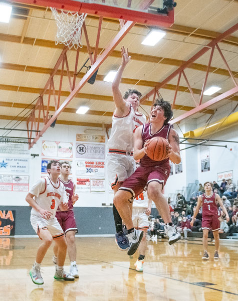 Rusty Rae/News-Register##
Nick Bettiga tries to score  on the break while  Kaleb Cruickshank puts a body on him.