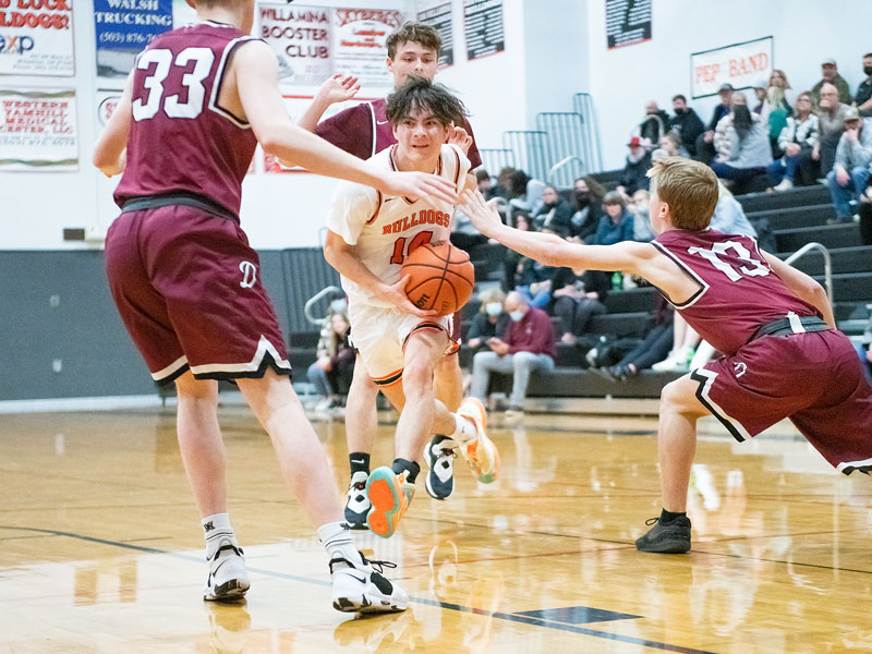 Rusty Rae/News-Register##
Willamina’s outstanding point guard, Cohen Haller (14) gets a taste of Dayton’s defense as three Pirate defenders surround Haller. Michael Freeborn (33) and Caleb Primbs (13) are the defensive players for Dayton.