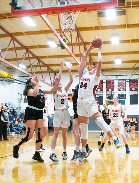 Rusty Rae/News-Register##
Cam Eaglestaff (34) dominated the inside against the Pirates, dropping 18 points while vacuuming the boards for nearly every caroom. Also pictured for Willamina are Kena Rankine (11),Brooklyn Bailey (2), and Hallee Hughes (21). Battling Bailey for the rebound  Dayton is Subby Harvel (42).