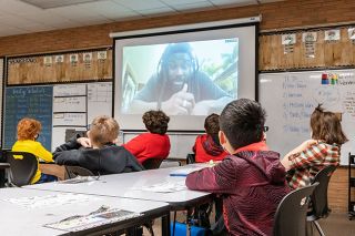 Marcus Larson/News-Register##Fifth-graders at Yamhill Carlton Intermediate School enjoy their virtual visit with popular young adult author Jason Reynolds just before Winter Break. Librarian Karissa Peterson wrote an essay and won the virtual visit for her students.
