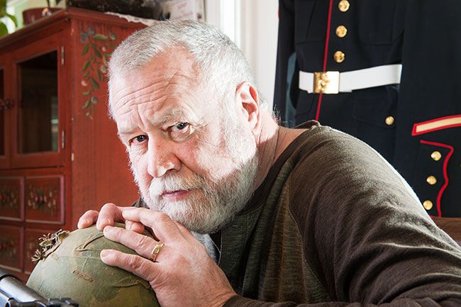 Rusty Rae/News-Register## Bob Moxley of Amity holds the helmet that took a bullet in Vietnam. Grazed and bleeding, he kept on fighting. He had just turned 19 at the time.