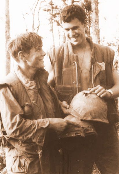 ## A photographer captured this picture of young Moxley and his buddy with the bullet-torn helmet. The round punctured Moxley’s helmet, then bounced off his fellow Marine.