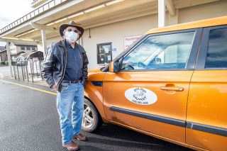 Marcus Larson/News-Register##Rick Connell of Rick Shaw delivery poses with his vehicle near the Bi-Mart Pharmacy pick-up window. During the COVID-19 pandemic, he has focused his business on medication and grocery pick-up from local stores.