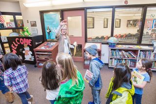 Marcus Larson/News-Register##
SMART volunteer coordinator JoAnne Myers waves goodbye to students after finishing their reading session in Wascher Elementary School library.