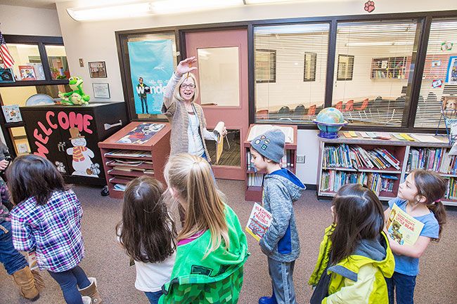 Marcus Larson/News-Register##
SMART volunteer coordinator JoAnne Myers waves goodbye to students after finishing their reading session in Wascher Elementary School library.