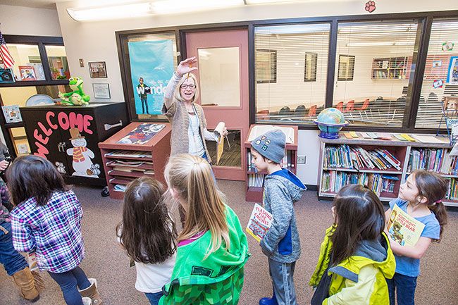 Marcus Larson/News-Register##
SMART volunteer coordinator JoAnne Myers waves goodbye to students after finishing their reading session in Wascher Elementary School library.