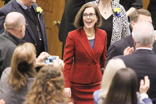 Rockne Roll/News-Register##
Oregon Gov. Kate Brown makes her way to the rostrum in the House or Representatives Chamber at the Oregon State Capitol in Salem during her inauguration ceremony.
