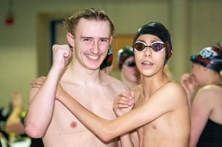 Rusty Rae/News-Register##Camden Parsons (left) celebrates with Ko Depweg (right) after winning the 100-yard breaststroke with a time of 1:08.34, a new personal best.