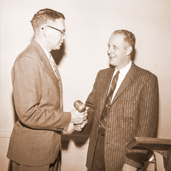 (January 8, 1958)##Gavel of the McMinnville Chamber of Commerce is handed over to Hoyt Reynolds, right, incoming president, by Joe Dancer, retiring president. Reynolds took over leadership of the Chamber during a Monday forum luncheon, first meeting of the new year.