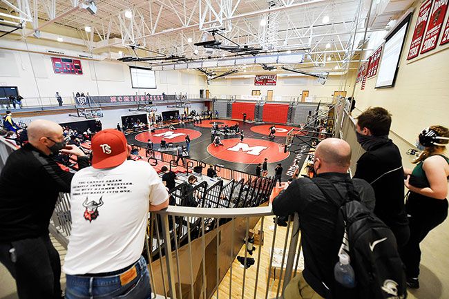 Rusty Rae/News-Register##
Some of the 400 participants at the MHS Your Storage Space Invitational wrestling tournament look over the four mats  and competition on the main floor at the tournament.