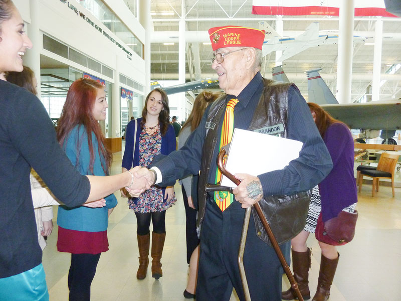 Starla Pointer/News-Register##Gunny Brandon shakes hands with students from McMinnville High School at a Veterans Day celebration at Evergreen Aviation Museum. The retired Marine was an active presence in the community, owning a variety of businesses. He was a veteran of both the Korean and Vietnam wars.