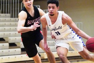 Submitted photo courtesy Nathan Herde##
Linfield freshman standout Trey Bryant blows by a Pacific defender during Tuesday’s Wildcat win, in which Bryant recorded the first triple-double in school history.