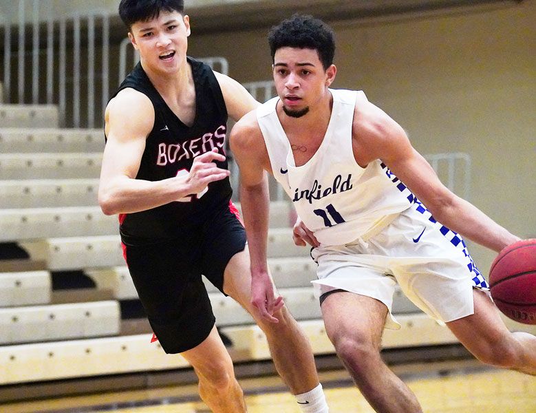 Submitted photo courtesy Nathan Herde## Linfield freshman standout Trey Bryant blows by a Pacific defender during Tuesday’s Wildcat win, in which Bryant recorded the first triple-double in school history.