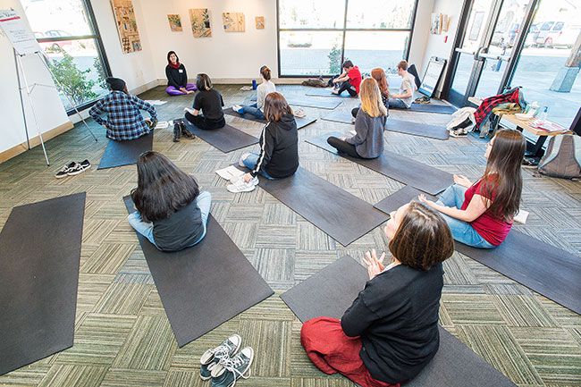 Marcus Larson/News-Register##
Tayler Brisbin leads  Connecting Yoga and Writing  class during the Fire Writers conference.