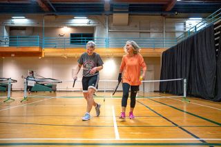 Rachel Thompson/News-Register##Laura Kenow (left) and Karen Willard share a laugh after winning a rally during a pickleball match at the McMinnville Community Center. As experienced players, the duo played together on the advanced court, where the competition rises.