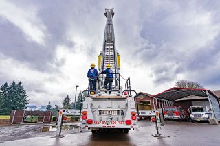 Marcus Larson/News-Register##Bobby Hatch, left, and Cooper Walters perform an inspection on a Grand Ronde Fire Department ladder truck at the station located off Grand Ronde Road.