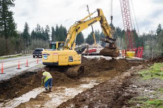 Rusty Rae/News-Register##Construction began Friday of the south-end dogleg on Three Mile Lane onto the temporary bridge across South Yamhill River bridge. Demolition of the existing bridge will start later this year.