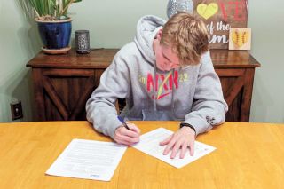 Submitted Photo## Reed signs his letter of intent to run at Western Colorado University. Reed said he fell in love with the campus on an unofficial visit and called it “a really good fit.”