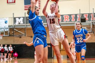 Rachel Thompson/News-Register##McMinnville’s Madison Gerhart fights through contact to earn an and-one at the end of the first quarter. Gerhart finished with 28 points, on 92 percent shooting, and 15 rebounds. Rachel Thompson/News-Register##McMinnville’s Madison Gerhart fights through contact to earn an and-one at the end of the first quarter. Gerhart finished with 28 points, on 92 percent shooting, and 15 rebounds.