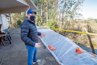 Marcus Larson/ News-Register ## Tyler Birman shows what remains of his home s back yard. The area was tarped off by a Hillsboro foundation stabilization business after much of the earth under the patio washed away during last week s heavy rain. Marcus Larson/ News-Register ## Tyler Birman shows what remains of his home s back yard. The area was tarped off by a Hillsboro foundation stabilization business after much of the earth under the patio washed away during last week s heavy rain.